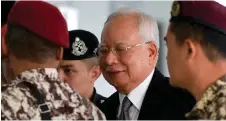  ?? — Bernama photo ?? Najib is led to the court for the continuati­on of his trial.