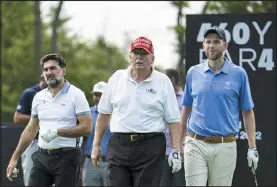  ?? DOUG MILLS — NEW YORK TIMES FILE ?? Former President Donald Trump, center, plays golf with his son Eric, right, and Yasir al-rumayyan, the governor of Saudi Arabia’s sovereign wealth fund, during a pro-am tournament at Trump National Golf Club Bedminster in New Jersey on July 28.