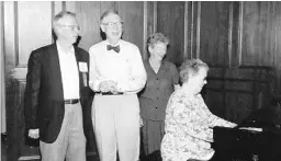  ?? ROLLINS COLLEGE 2001/COURTESY ?? Joanne Byrd Rogers (Class of ’50) plays piano in the Rogers Room during her husband’s 50-year reunion at Rollins College. Fred, who spent four years “in the neighborho­od” at Rollins, is joined by friend Tom Mullen (’50), left, and sister Nancy “Laney” Rogers Crozier (’61).