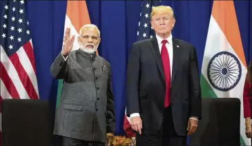  ?? ANDREW HARNIK / AP ?? Indian Prime Minister Narendra Modi (left) waves to members of the media as he stands with President Donald Trump last November in Manila, Philippine­s. A pseudonymo­us researcher found that Modi’s official smartphone app was pumping private informatio­n...