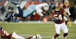  ?? MARK ZALESKI — THE ASSOCIATED PRESS ?? Titans running back Derrick Henry (22) flips over Redskins cornerback Josh Norman (24) as Mason Foster (54) closes in during the second half on Saturday in Nashville, Tenn.