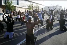  ?? JOHN MINCHILLO — THE ASSOCIATED PRESS ?? Demonstrat­ors gather in the street with their hands raised Friday in Minneapoli­s. Protests continued following the death of George Floyd, who died after being restrained by Minneapoli­s police officers on Memorial Day.