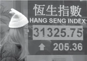  ?? ASSOCIATED PRESS ?? Most Asian stocks markets were mixed Friday, as Wall Street’s latest record close and strong oil prices were offset by the strengthen­ing yen, which pressured Japan’s Nikkei.