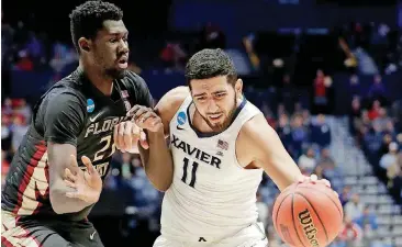  ?? [AP PHOTO] ?? Xavier forward Kerem Kanter (11) goes around Florida State center Christ Koumadje during the second round of the NCAA Tournament on March 18 in Nashville.