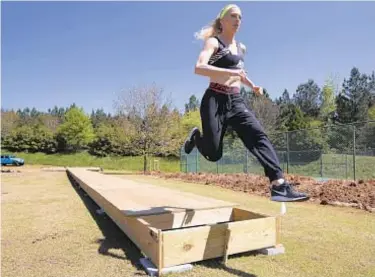  ?? AP ?? Olympic pole vaulter Sandi Morris got creative to continue training by building her own pit (above).