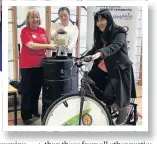  ??  ?? Rutherglen MP Margaret Ferrier tries the smoothie bike, on a visit to St Mark’s Primary( pictured right)