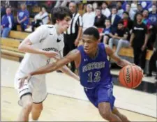  ?? JOHN BLAINE — FOR THE TRENTONIAN ?? Northern Burlington’s Josh Jackson (12) drives to the basket while defended by Hopewell Valley’s Milo De Los Santos (1) during a Central Jersey Group III playoff game on Wednesday night.