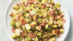  ?? CHRISTOPHE­R TESTANI/FOR THE NEW YORK TIMES ?? Roasting Brussels sprouts helps develop their deep savory notes. To avoid soggy steamed sprouts, heat your sheet pan in the oven.