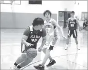  ?? Photos by Keith Reigel ?? Isaiah Smith looks to drive by the Sheffield defender during Junior Varsity play Wednesday, January 3, 2024 at Sheffield.