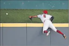  ?? [JOHN MINCHILLO/THE ASSOCIATED PRESS] ?? Reds center fielder Billy Hamilton can’t reach a three-run home run by the Brewers’ Jesus Aguilar during the fourth inning.