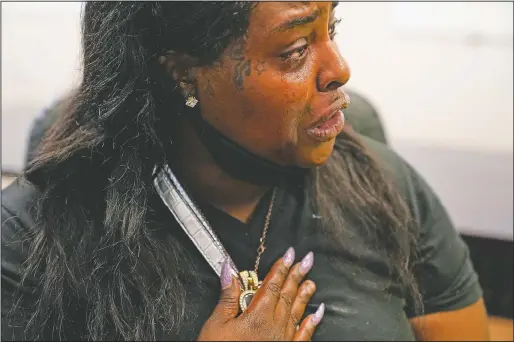  ??  ?? Natisha Stansberry cries as she holds a locket of her child close to her chest in St. Louis. Stansberry was a victim of childhood sexual assault and her brother was murdered. She was told during a drug test rat poison and fentanyl were found in her urine test when she went to Assisted Recovery Centers of America for help with her drug addiction. (AP/Brynn Anderson)