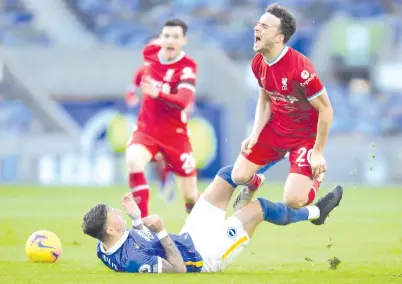  ?? AFP photo ?? Brighton’s defender Ben White tackles Liverpool’s striker Diogo Jota (right) during the English Premier League football match. -