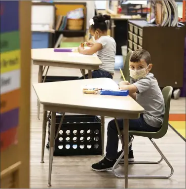  ?? ASSOCIATED PRESS ?? In this Aug. 27photo, first-grade students at Dunmore Elementary Center in Dunmore, Pa., wear face masks on their first day of classes.