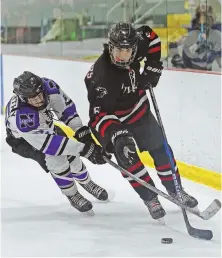  ?? STAFF PHOTO BY JOHN WILCOX ?? ON THE GO: Holliston’s Tim Ringie moves the puck past Norton’s William McCarthy Wednesday in Foxboro.