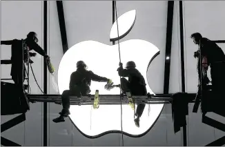  ?? CHANCE CHAN / REUTERS ?? Workers prepare for the opening in January of an Apple store in Hangzhou, China. Apple’s iPhone sales grew 72 percent in China, where the company has big hopes for expansion.