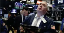  ?? RICHARD DREW — THE ASSOCIATED PRESS ?? Trader Edward McCarthy works on the floor of the New York Stock Exchange, Thursday.