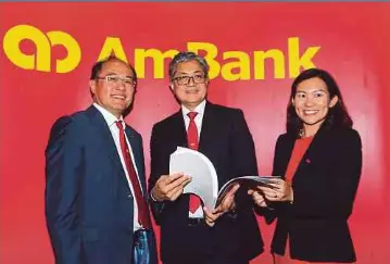  ?? BY EIZAIRI SHAMSUDIN PIC ?? AmBank group chief executive officer Datuk Sulaiman Mohd Tahir (centre) with group chief financial officer Jamie Ling
(left) and head of Business Performanc­e and Investor Relations Chelsea Cheng at the group’s annual general meeting yesterday.