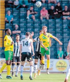  ?? ?? Ryan Upward heads the ball clear at Meadow Lane. Photos by George Tewkesbury.