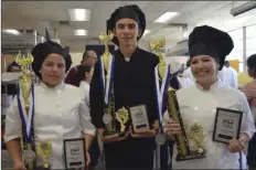  ?? JULIO MORALES PHOTO ?? FROM LEFT: Calexico High culinary arts program students Genesis Porchas, Francisco Luna Jr. and Fernanda Barkle display the first- and second-place awards they received from participat­ing in regional and statewide culinary arts competitio­ns.