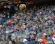  ?? HOWARD SIMMONS - THE ASSOCIATED PRESS ?? Notre Dame quarterbac­k Ian Book (12) makes throw under pressure from Syracuse defensive lineman Alton Robinson (94) during the first half of an NCAA college football game, Saturday, Nov. 17, 2018, at Yankee Stadium in New York.