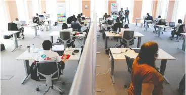  ?? ARIS OIKONOMOU/AFP via Get y Images ?? Open work spaces, like this call centre in Brussels, are being adapted.