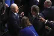 ?? PATRICK SEMANSKY — THE ASSOCIATED PRESS ?? President Joe Biden greets people as he arrives in the House chamber at the U.S. Capitol in Washington on Tuesday to deliver the State of the Union address to a joint session of Congress.