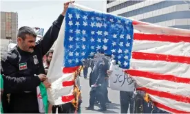  ??  ?? Iranian demonstrat­ors burn a makeshift US flag during a rally in Tehran last week. Photograph: STR/AFP/Getty Images