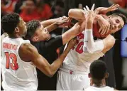  ?? Julie Jacobson / Associated Press ?? Syracuse’s Tyler Lydon (20) grabs a rebound against South Carolina’s Maik Kotsar as Orange teammate Paschal Chukwu (13) lends a helping hand.