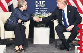  ??  ?? PUT IT THERE Mrs May and Mr Trump at Davos talks yesterday