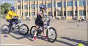  ?? MARIA DANILOVA / AP ?? Second-graders learn to ride bikes at Seaton Elementary School in Washington. At a time when elementary and high schools are all about getting students ready for college or jobs, physical education teachers are being urged to look beyond graduation, too.