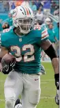 ?? AP/LYNNE SLADKY ?? Kenyan Drake runs the last 52 yards as the Miami Dolphins scored on a pass and double lateral on the final play Sunday to beat the New England Patriots 34-33 in Miami Gardens, Fla.