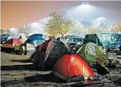  ?? JOSH EDELSON/GETTY-AFP ?? Evacuees from the worst-ever wildfire to hit California rest in their tents for the night in a Walmart parking lot in Chico.