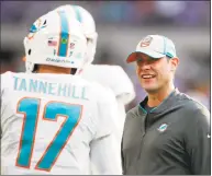  ?? Jeff Haynes / Associated Press ?? Miami Dolphins head coach Adam Gase talks with quarterbac­k Ryan Tannehill before a game against the Minnesota Vikings on Dec. 16 in Minneapoli­s. Gase will be introduced as the coach of the New York Jets on Monday.