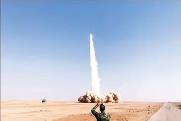  ?? STRINGER/AFP ?? A rocket is fired by Syrian forces from the village of Suway’iah, near the Syrian border town of Albu Kamal, on Friday.