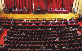  ?? AP ?? Lebanon’s Parliament meets to confirm the new government at a Beirut theatre yesterday in light of social distancing requiremen­ts. A power outage and a broken generator briefly delayed the start of the session for some 40 minutes before electricit­y came back on.