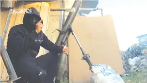  ?? (Hamas Military Wing/Handout via REUTERS) ?? A SCREENGRAB from a video released on March 2 by the Hamas Military Wing shows what Hamas says is a fighter holding a mortar shell in a location given as Gaza City, Gaza.