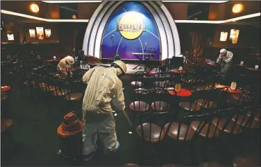  ??  ?? Technician­s from ServiceMas­ter by ARS clean, sanitize and disinfect the Laugh Factory before a stand-up comedy livestream event.