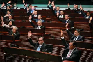  ?? AFP PHOTO ?? DISQUIETIN­G DECISION
Lawmakers vote for Article 23 in the chamber of the Legislativ­e Council after the conclusion of the readings of the said article in Hong Kong on Tuesday, March 19, 2024.