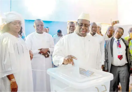  ?? — AFP ?? Macky Sall casts his vote for Senegal’s presidenti­al elections in a ballot box at a polling station in Fatick.