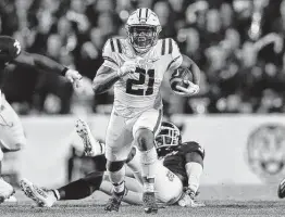  ?? Jonathan Bachman / Getty Images ?? Corey Kiner and LSU denied Texas A&M its first road conference win against the Tigers. With the victory, LSU became bowl eligible at 6-6.