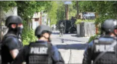  ?? TRENTONIAN FILE PHOTO ?? New Jersey State Police TEAMS unit officers are seen at the rear of 343Federal Street where a man had barricaded himself inside after a shootout with police on May 10, 2017.