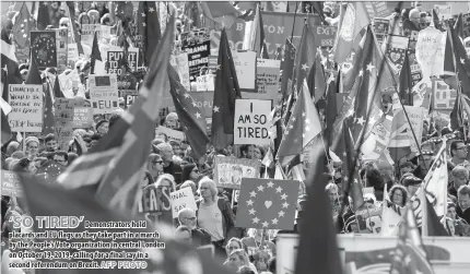  ?? AFP PHOTO ?? Demonstrat­ors hold placards and EU flags as they take part in a march by the People’s Vote organizati­on in central London on October 19, 2019, calling for a final say in a second referendum on Brexit.