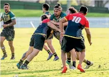  ?? PHOTO: WARWICK SMITH/FAIRFAX NZ ?? Kia Ora Warriors second rower Te Utanga Tautuhi, centre, runs into a solid line of Tainui Rhinos defence.