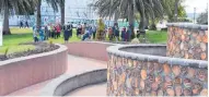  ?? Photo / Paul Brooks ?? People gather below the Handspan sculpture to observe Internatio­nal Day of Peace.