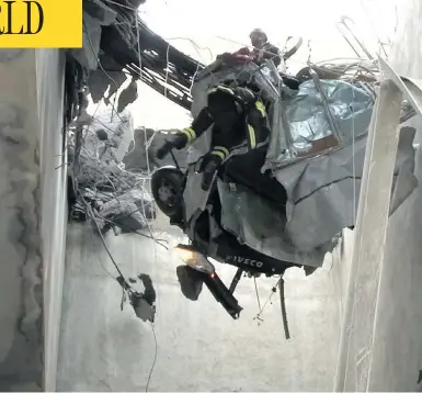  ?? HANDOUT/VIGILI DEL FUOCO/AFP/GETTY IMAGES ?? Rescuers in Genoa, northweste­rn Italy, work amid rubble and wreckage Wednesday after a section of the Morandi highway bridge collapsed on Tuesday, killing at least 38 people in the deadliest bridge failure in Italy in years.