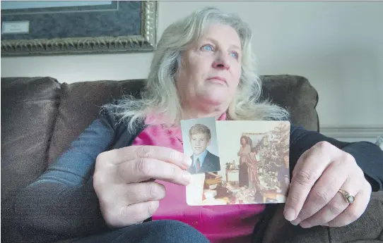  ?? PETER J. THOMPSON ?? Sandra Stewart holds photos of her late brother, John Michael Stewart. She recently contacted the SQ and hopes the murder file will be reopened as a cold case.