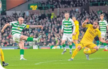  ??  ?? Scott Brown fires home Celtic’s second in the 4-0 victory over Livingston