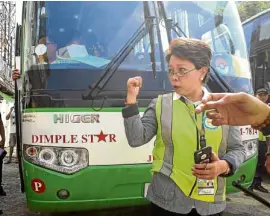  ?? —JAMSTA. ROSA ?? Lawyer Aileen Lizada of the LTFRB inspects the station of Dimple Star Transport on Edsa in Quezon City following the accident involving one of the firm’s buses in Occidental Mindoro province.