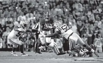  ?? ASSOCIATED PRESS FILE PHOTO ?? Alabama running back Joshua Jacobs carries as LSU defensive tackle Davon Godchaux and linebacker Kendell Beckwith, right, close in during their Nov. 5, 2016, game in Baton Rouge, La. Alabama won 10-0.