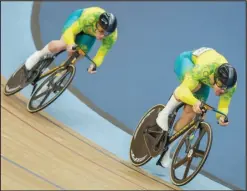  ?? Associated Press ?? Matthew Glaetzer (right), of Australia, leads compatriot Thomas Cornish in their men’s sprint quarterfin­als during the Commonweal­th Games track cycling, Sunday, at Lee Valley VeloPark in London.